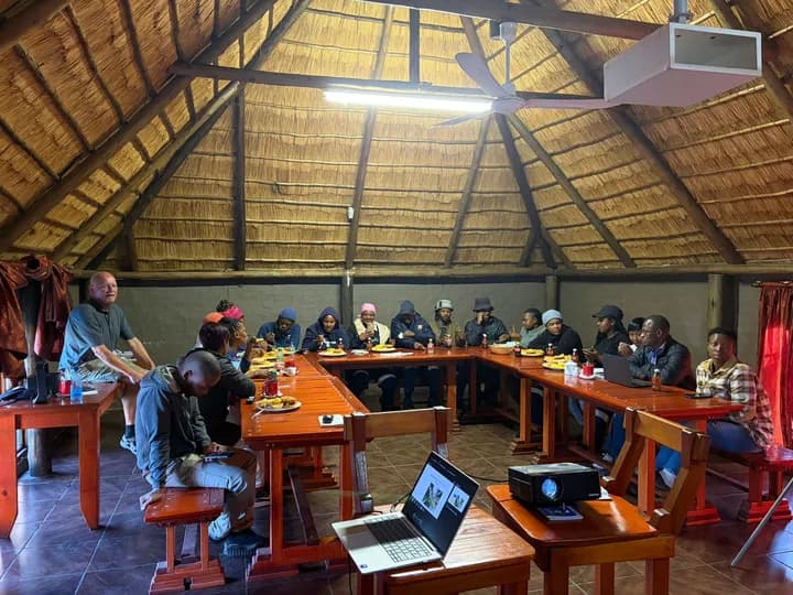 Grootvlei trainee cohort gathered around tables during a group training session